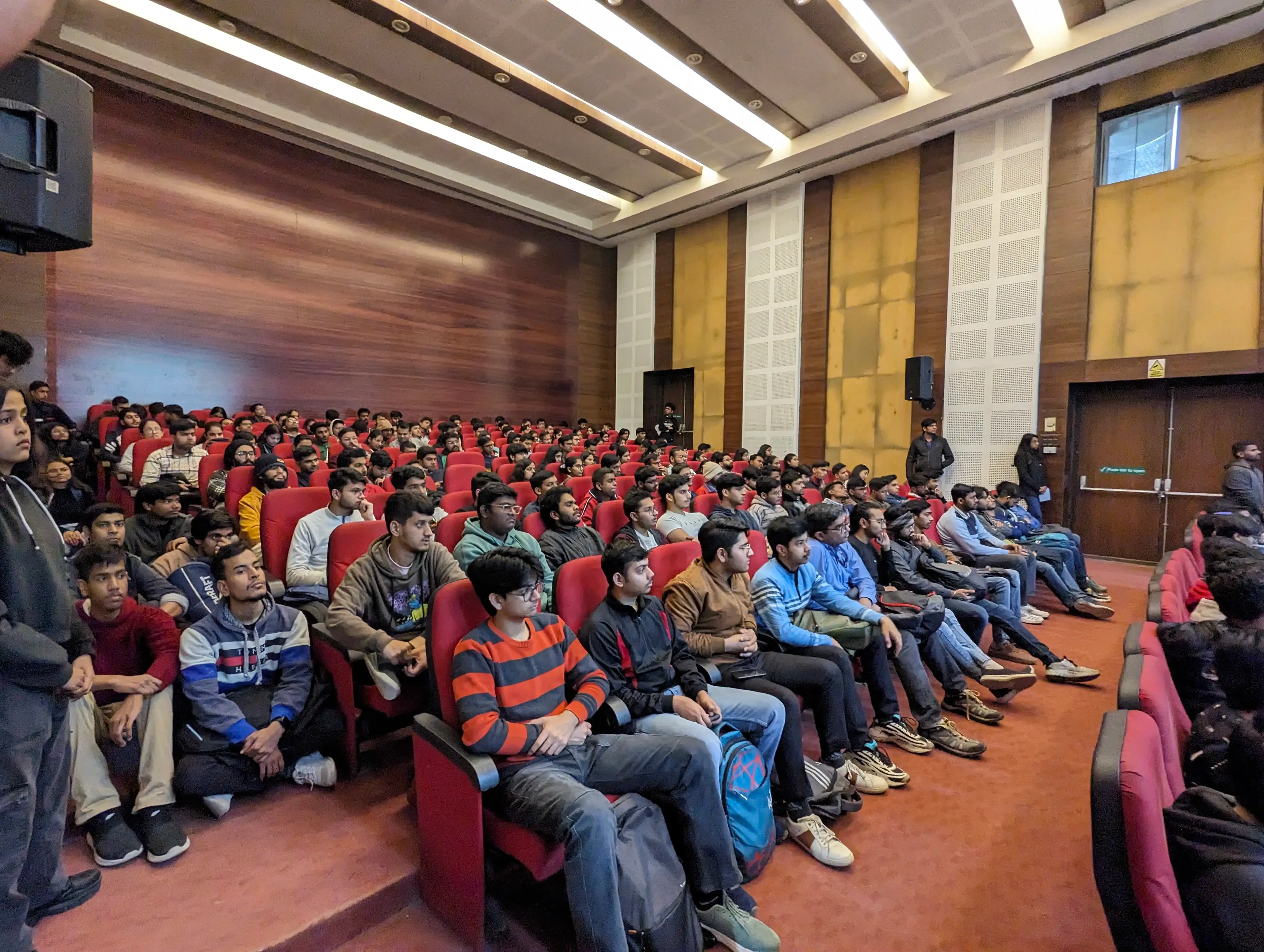College seminar with students and speakers discussing academic topics